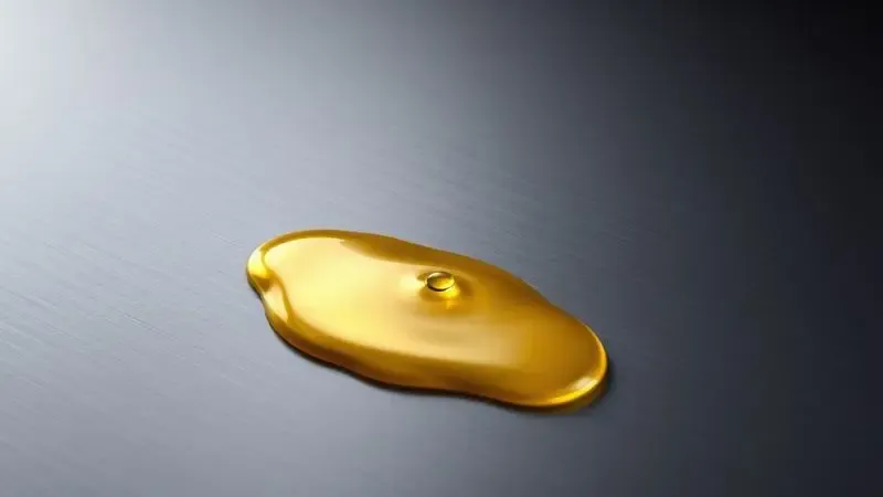 Representação artística do processo de cura de uma panela de ferro com uma gota de óleo criando uma camada protetora brilhante.
