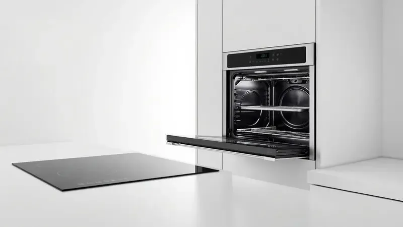 Renderização 3D de superfícies de cozinha modernas demonstrando compatibilidade com indução e forno.
