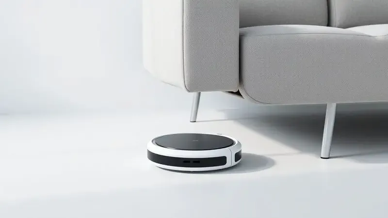 Ilustração 3D de um robô aspirador com design fino passando facilmente por baixo de um sofá moderno.