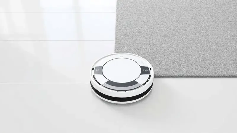 Ilustração conceitual de um robô aspirador transitando suavemente de um piso frio para um tapete fino.